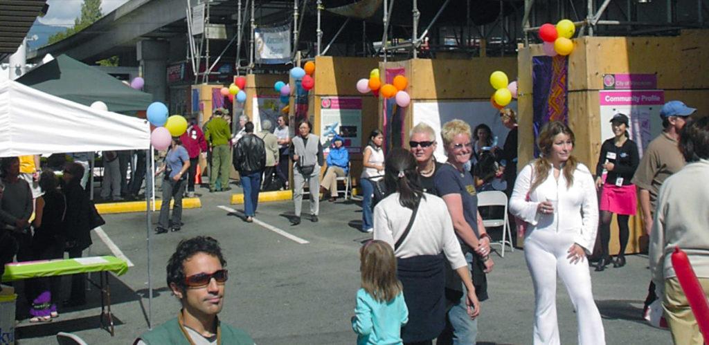 A community festival occurs between scaffolding in a construction area