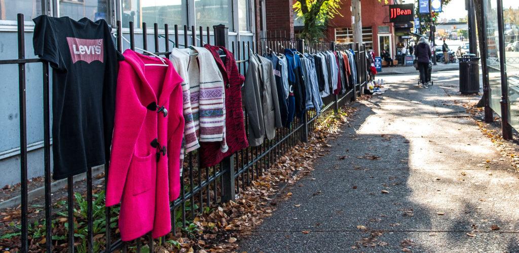 A clothing vendor sells clothes along a sidewalk