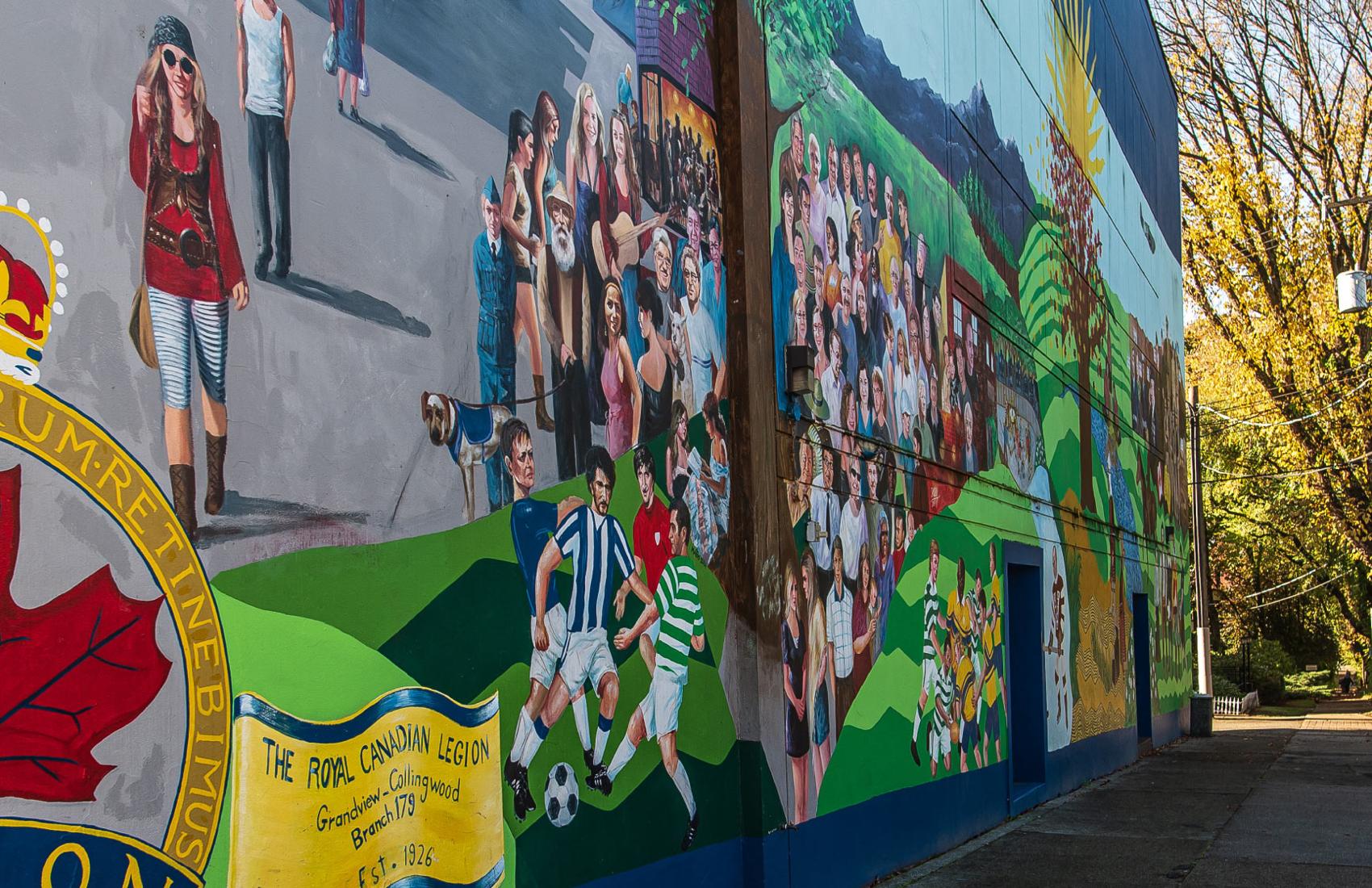A colourful mural along an outdoor wall of an old building