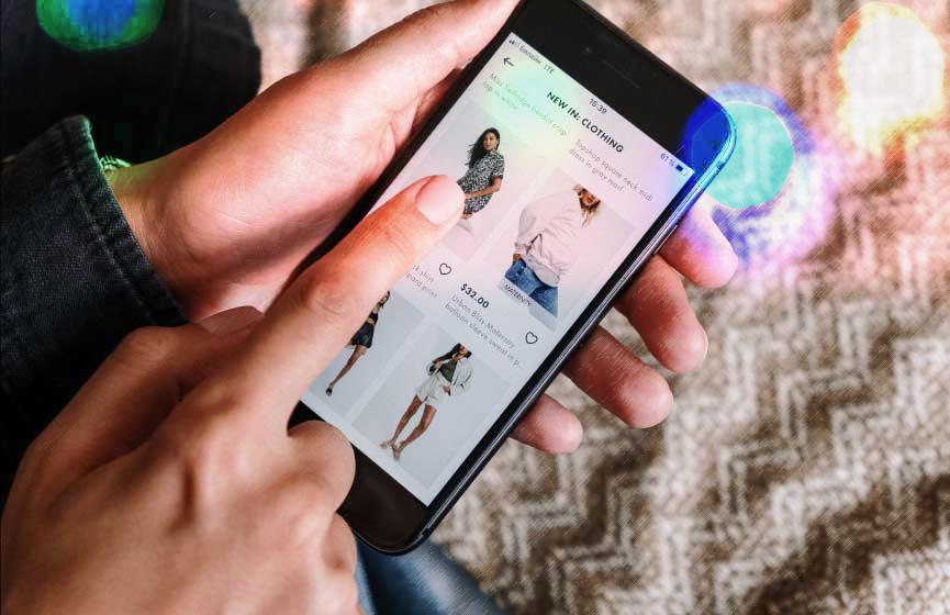 A person shops online on their phone, keeping safe from COVID-19