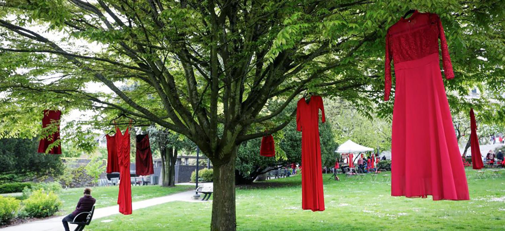 Red dresses are seen hanging on trees to commemorate missing and murdered Indigenous women and girls outside the City Hall in Vancouver, British Columbia, Canada, on May 5, 2021. May 5 is the National Day of Awareness for Missing and Murdered Indigenous Women and Girls in Canada, also known as Red Dress Day.