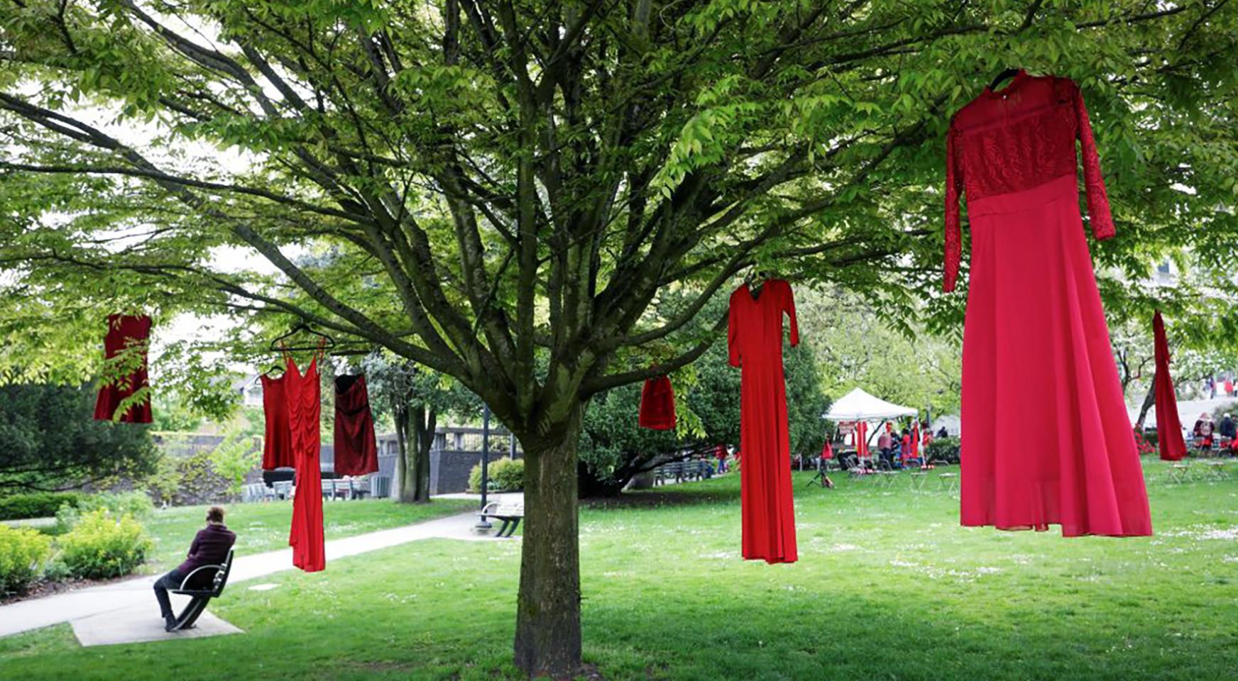 Red dresses are seen hanging on trees to commemorate missing and murdered Indigenous women and girls outside the City Hall in Vancouver, British Columbia, Canada, on May 5, 2021. May 5 is the National Day of Awareness for Missing and Murdered Indigenous Women and Girls in Canada, also known as Red Dress Day.
