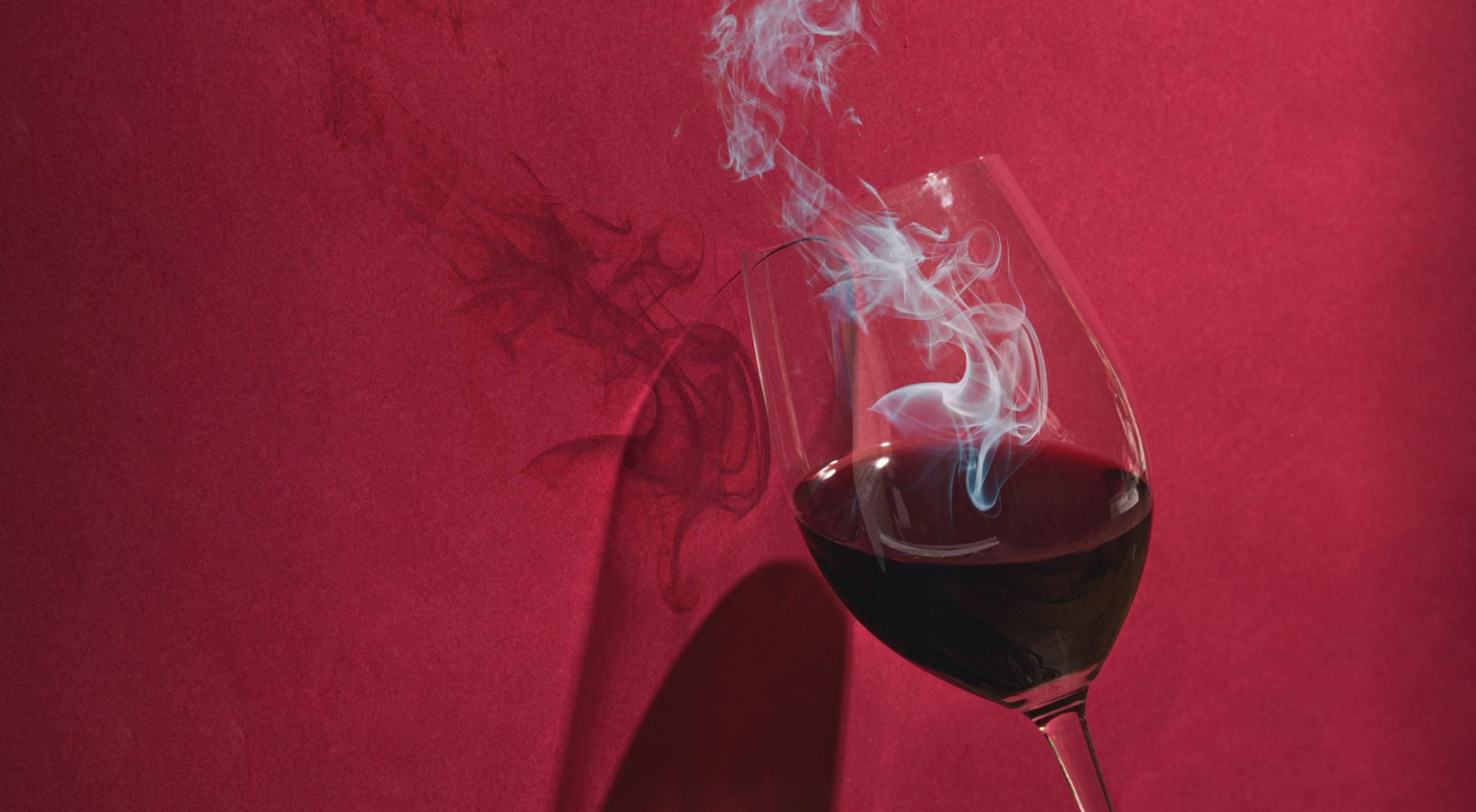 Photo illustration of fire coming out of a wine glass to illustrate smoky tasting wine