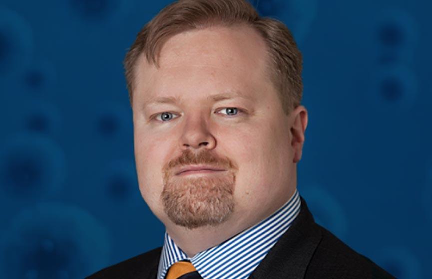 Photo of UBC Faculty of Medicine's Dr. Michael Curry on a blue background