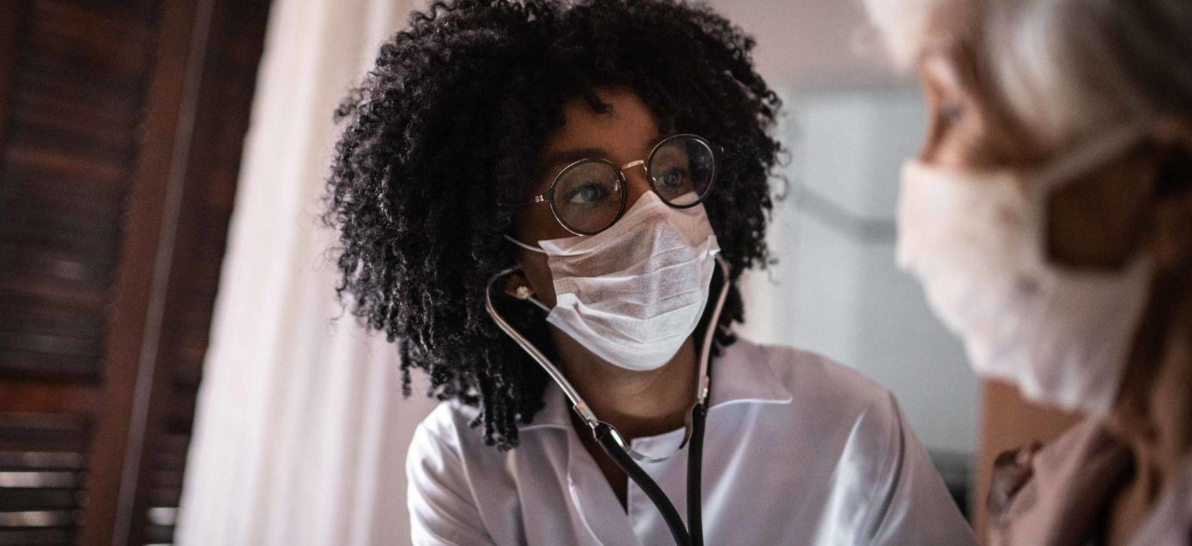 Doctor using stethoscope on a senior patient