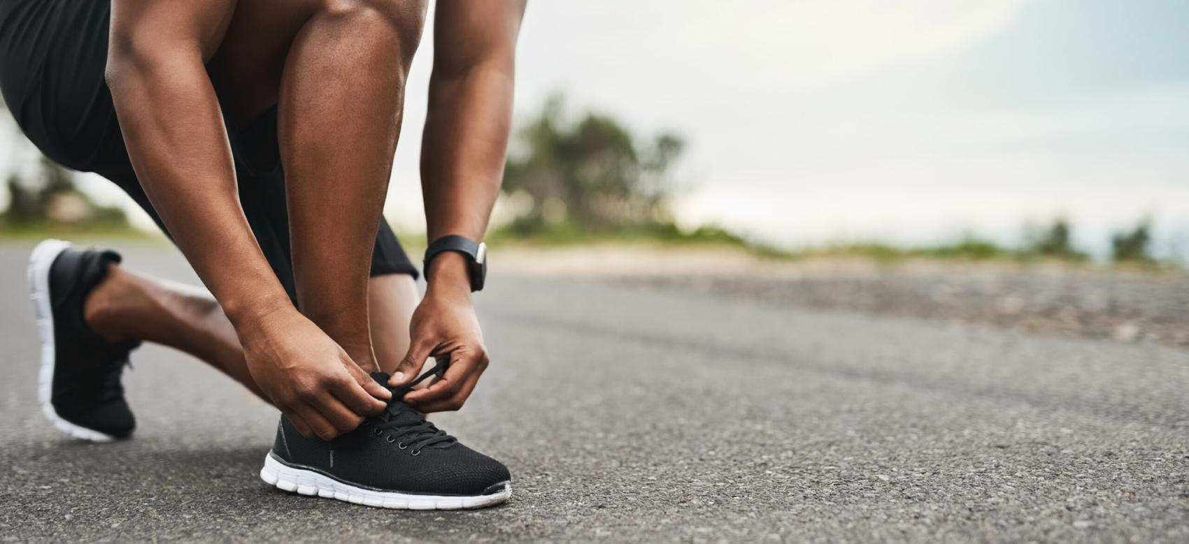 Closeup shot of a man tying shoelaces in outdoors