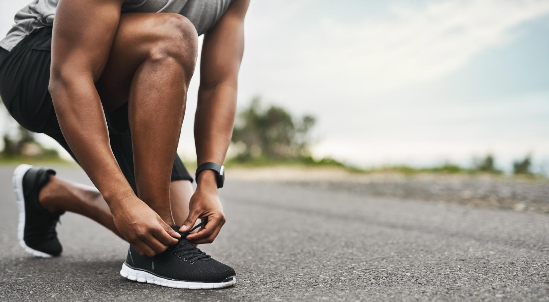 Closeup shot of a man tying shoelaces in outdoors