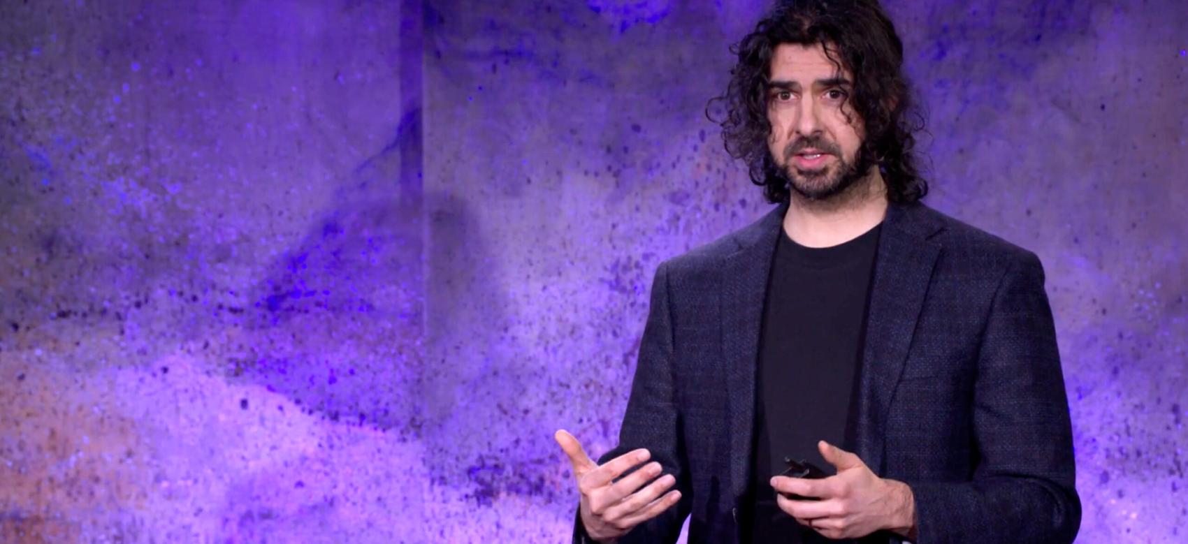 Photo of Azim Shariff on stage at TED