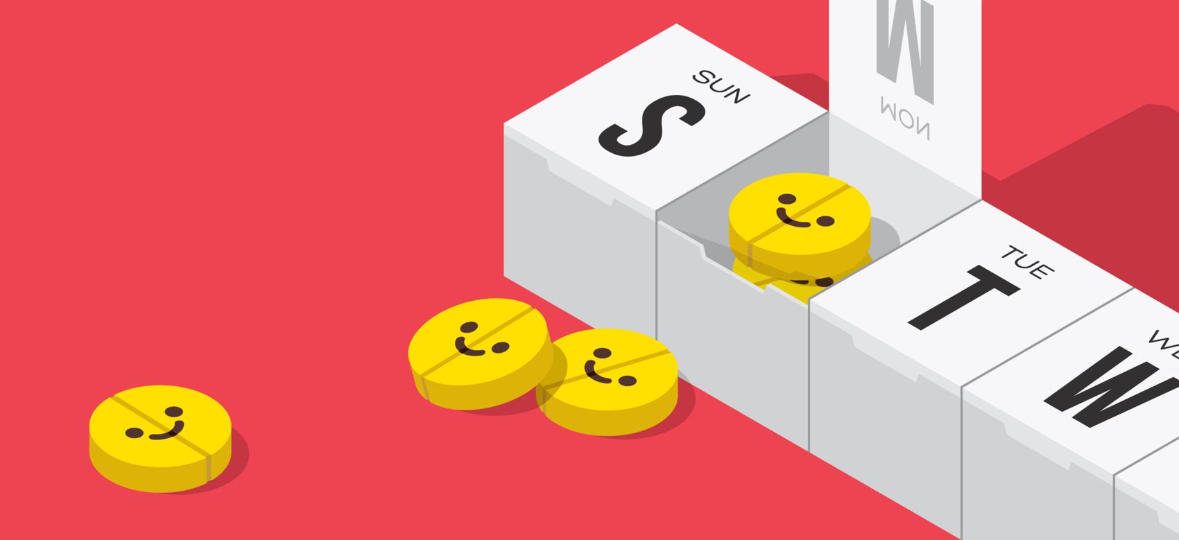 A weekly pill organizer with several happy pills arranged around it.