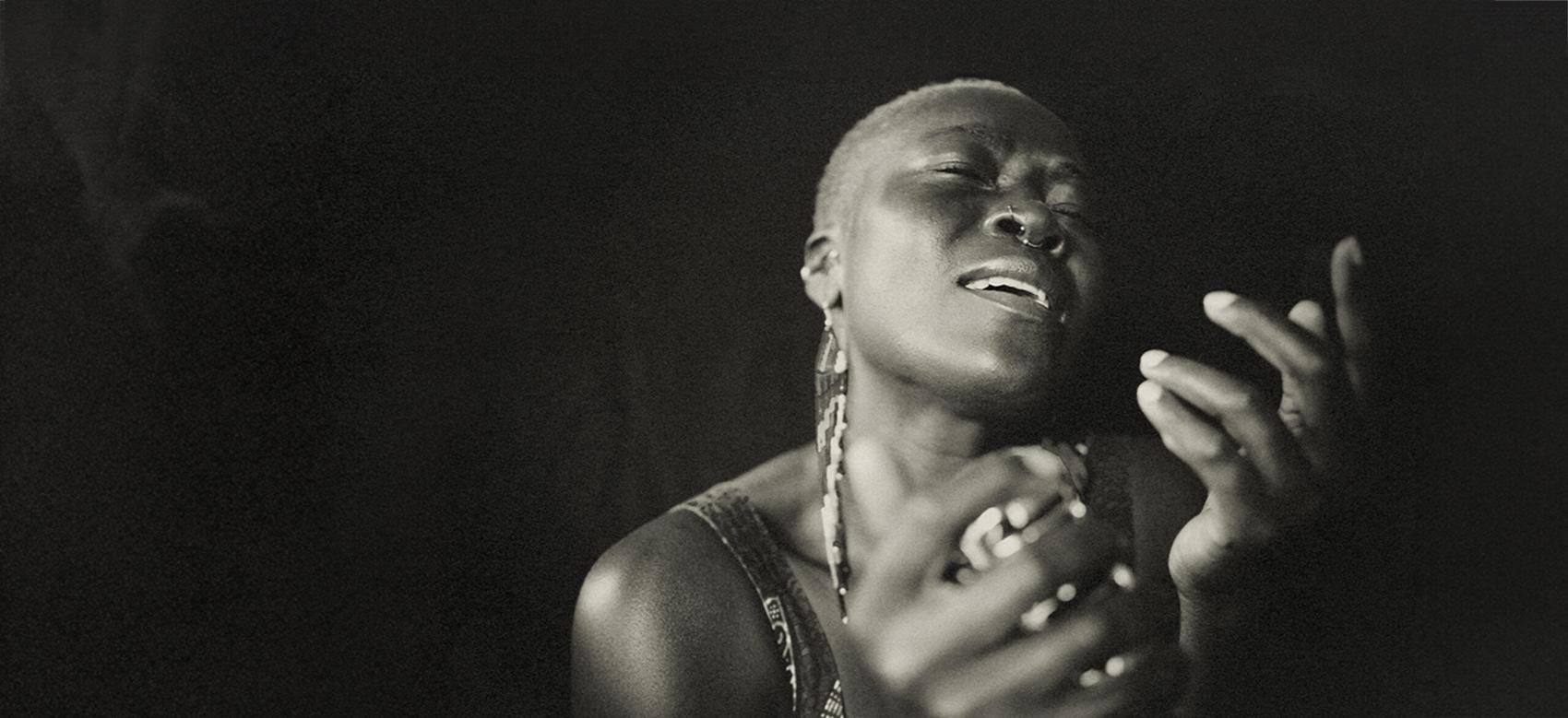 Black and white portrait of a Black musician singing.