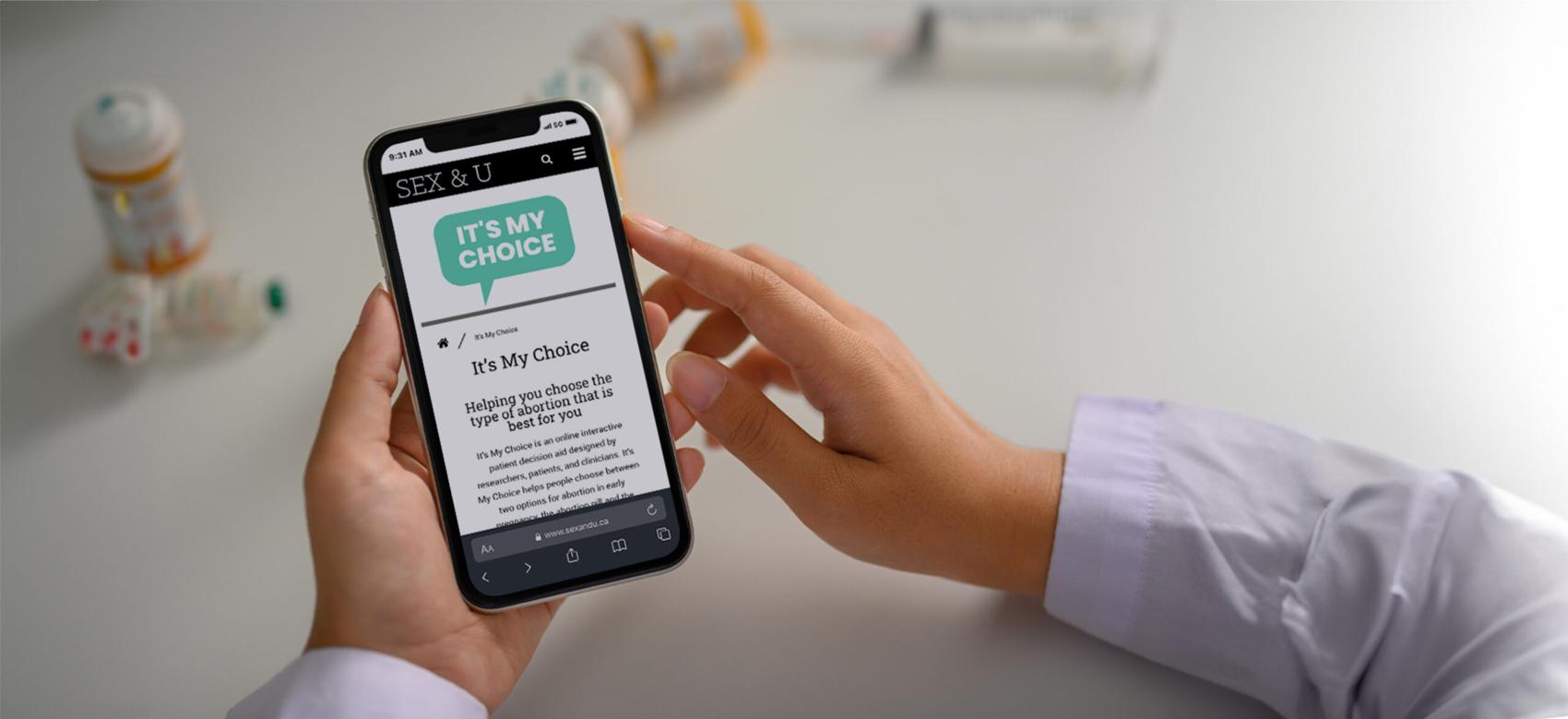 Doctor in a white coat browsing the 'It's My Choice' website.